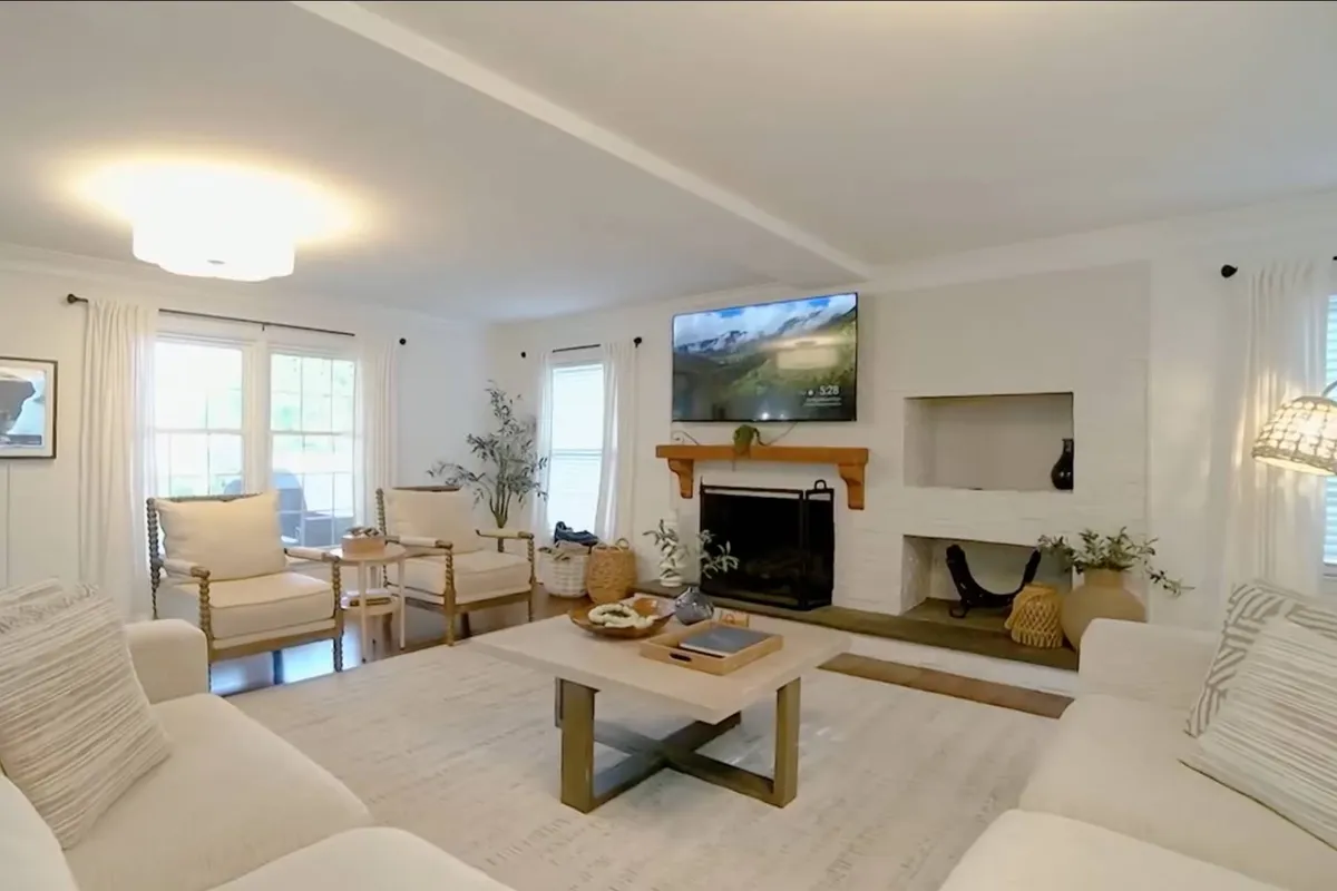 A welcoming living space featuring a cozy fireplace, comfortable seating, and a large television. The inviting atmosphere suggests group gatherings and intimate moments, making it a hub for holiday celebrations and winter evenings.